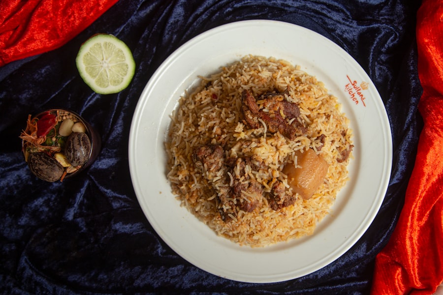 Long grain rice and bone-in chicken plated together, garnished with fried onion