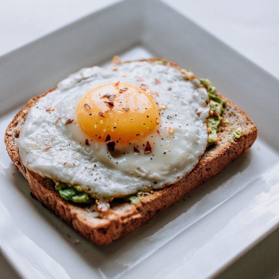 A fried egg with a soft yolk on toasted bread, served on a white plate